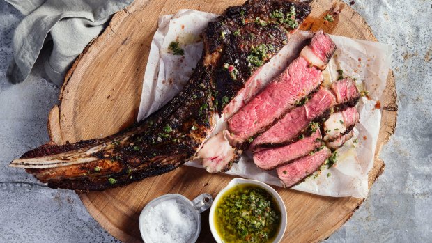 Beef tomahawk steak with chimichurri.