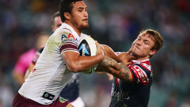 Rivalry: Manly's Justin Horo puts a fend on Roosters hooker Jake Friend during the 2013 grand final.