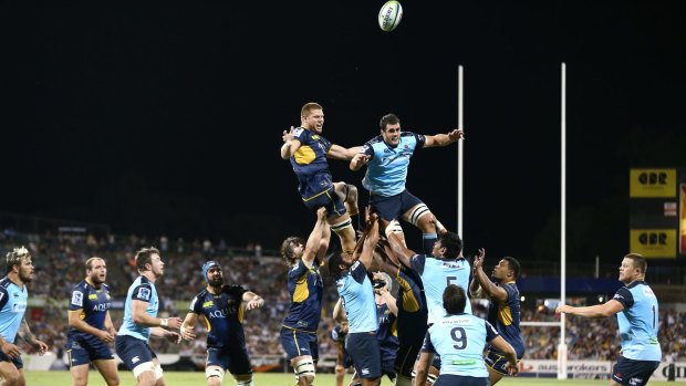 Blake Enever and Dave Dennis compete for the ball in the Brumbies-Waratahs match on Friday night. Enever injured his shoulder in the second half.