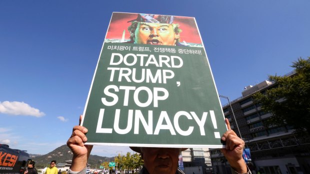 A South Korean protester holds up a sign during a rally against US President Donald Trump's upcoming visit.