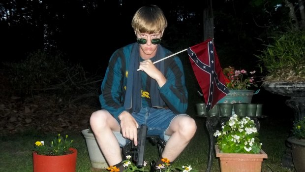 Dylann Roof poses for a photo while holding a Confederate flag in a white supremacist post published by a website investigated by the FBI. 