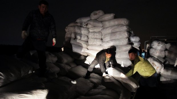 South Korean workers unload products made at the Kaesong joint industrial complex in North Korea on Thursday.  