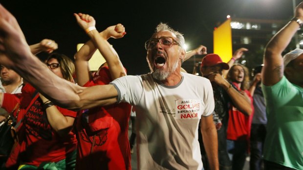 Pro-government supporters chant at a demonstration against the impeachment of Brazilian President Dilma Rousseff outside the National Congress building on Wednesday.