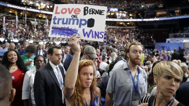 A "love trumps hate" sign issued by the Hillary Clinton campaign is modified by a Sanders supporter on the convention floor.