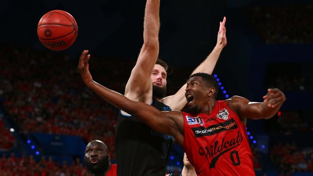 Up he goes: Jermaine Beal lays up against Alex Pledger during game three of the NBL Grand Final series between the Perth Wildcats and the New Zealand Breakers at Perth Arena.