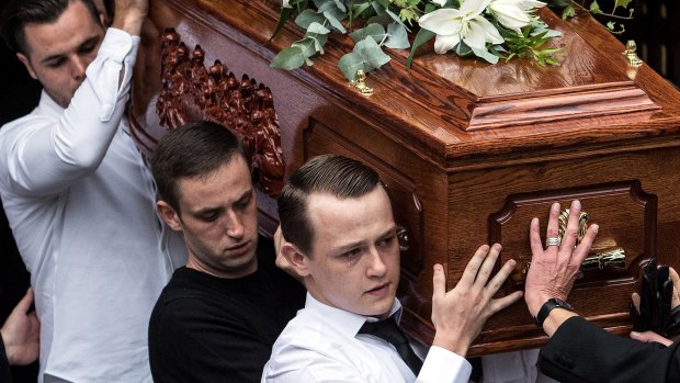 The coffin of 65-year-old Tony Disson is carried out of church in London.