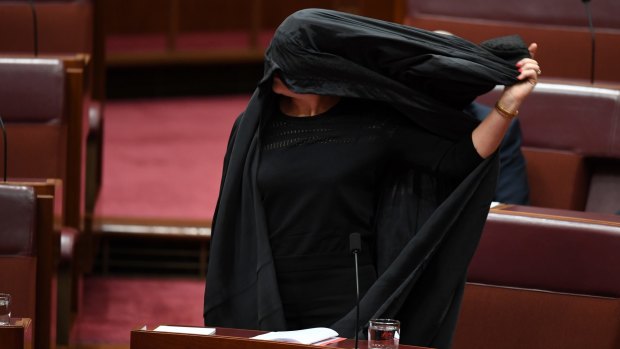 Pauline Hanson removes her burqa after the Senate stunt.