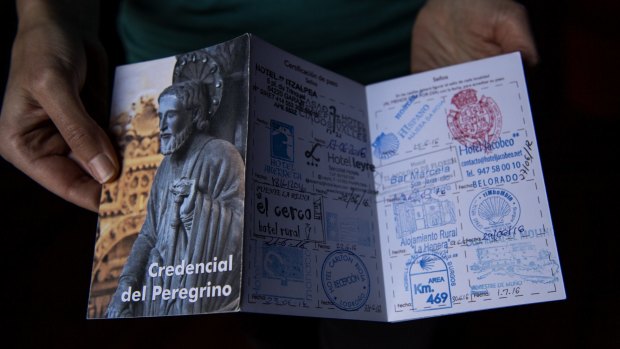 Giselle Oscuro holds a Camino de Santiago pilgrim passport.