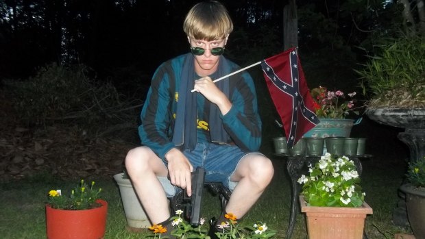 This photo allegedly showing Dylann Roof was found on a website with a white supremacist manifesto and dozens of photographs of the alleged Charleston shooter holding weapons, burning an American flag and visiting historic sites in the US South.
