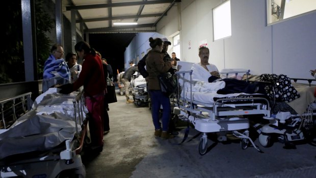 Patients and family members are seen outside a hospital in Puebla, Mexico, after an earthquake struck off the southern coast of Mexico late on Thursday.