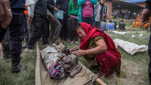  A relative of one of the victims of the earthquake that hit Nepal cries while identifying the body in Bhaktapur, Nepal. 