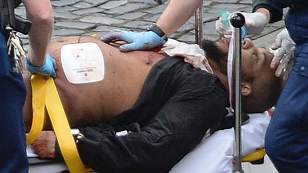 Khalid Masood is treated by emergency services outside parliament. 