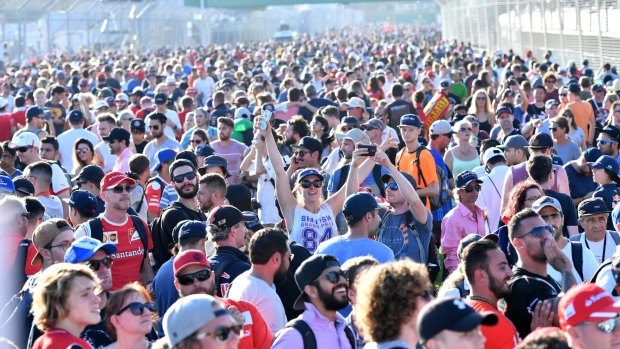 Taking it to the track: Grand Prix fans celebrate after the race at the Albert Park circuit.