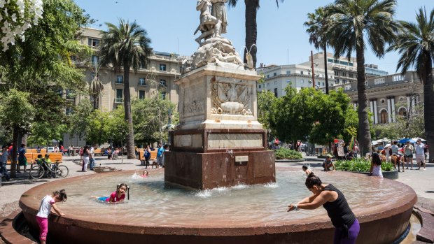 Children play in a fountain in Plaza de Armas in the centre of Santiago.