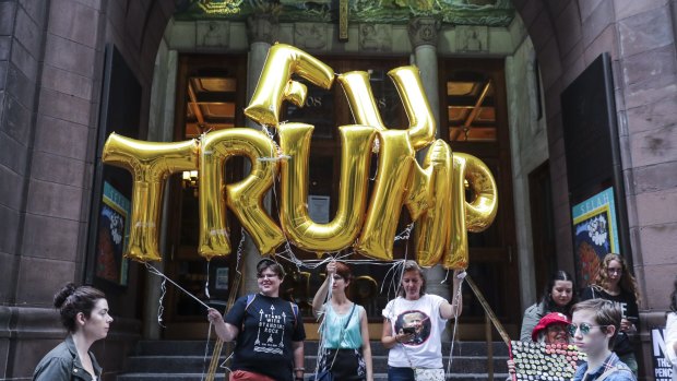 Demonstrators hold balloons during a rally outside of Trump Tower in New York on Monday.