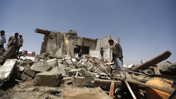 People inspect houses destroyed by a Saudi-led airstrike on the outskirts of the Yemeni capital Sanaa this week.