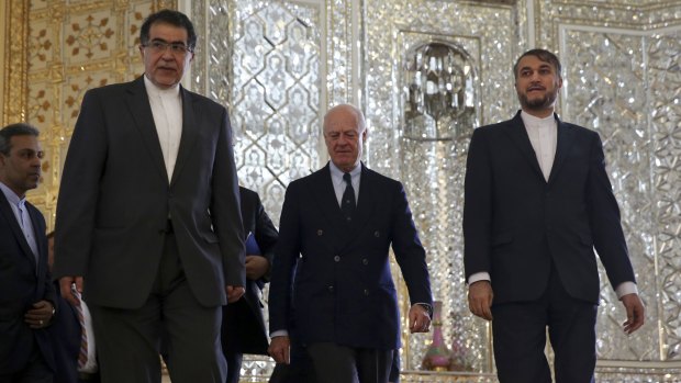 UN Special Envoy for Syria, Staffan de Mistura, centre, arrives for a meeting with Iranian Foreign Minister Mohammad Javad Zarif, as he is accompanied by deputy Foreign Minister, Hossein Amir Abdollahian, right, in Tehran, Iran, on Sunday.