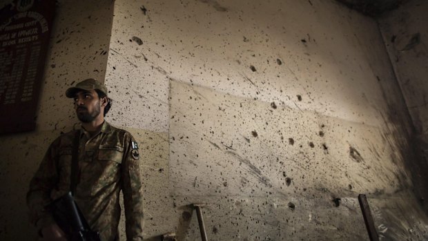 A soldier stands guard inside the school that was attacked.