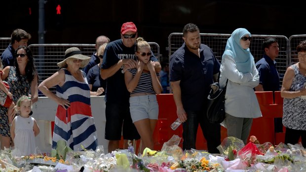 Mourning: Thousands continue to pay tribute to the victims of the Lindt Cafe seige.