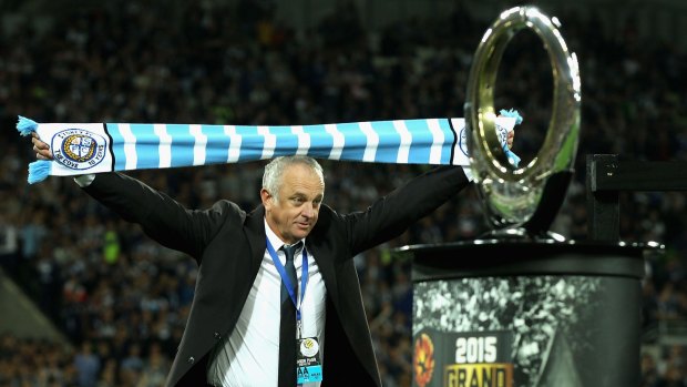 Still proud: Graham Arnold walks up to receive a runners up medal.