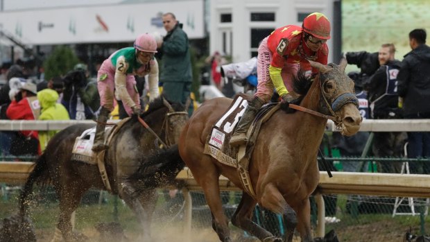 Willing: Abel Tasman carries the China Horse Club colours to victory in the Kentucky Oaks.
