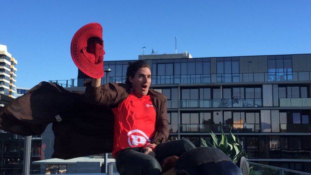 From the wild west: Brad Hogg takes a ride on a mechanical bull on Monday.