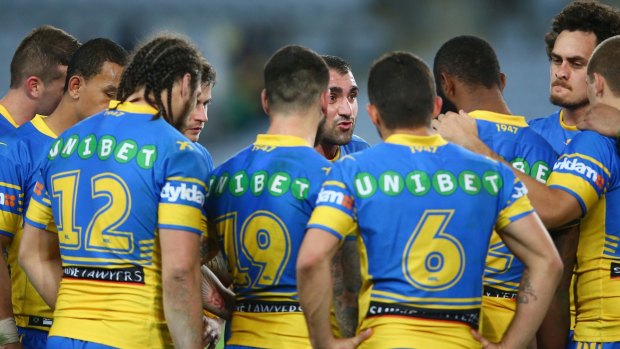 Dejected:  Tim Mannah of the Eels speaks to his players in a huddle after the loss.