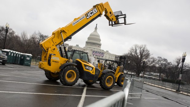 A forklift stands in front of security fences near the US Capitol building. Reported inauguration plans such as a parade on New York's Fifth Avenue, after which Trump was to fly to Washington by helicopter, have been abandoned.