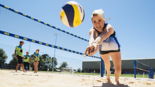 Emily Larkin dives for the ball on to the sand at the Lyneham Beach Sports Facility.
