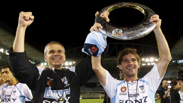 Hard road: Vitezslav Lavicka and Karol Kisel of Sydney hold the trophy after the 2010 A-League grand final.
