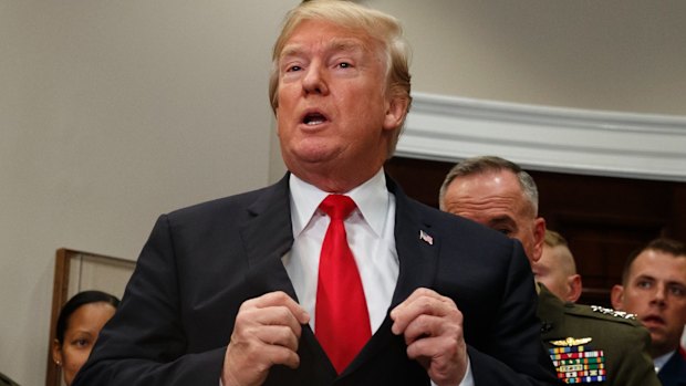 President Donald Trump adjusts his suit jacket on Tuesday.