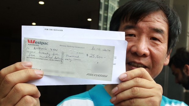 Cleaner Anping Yan leaving court with the cancelled cheque. 