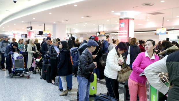 Passengers are seen waiting in long queues as a result of Australian Border Force staff holding a two-hour strike at Melbourne Airport last year.