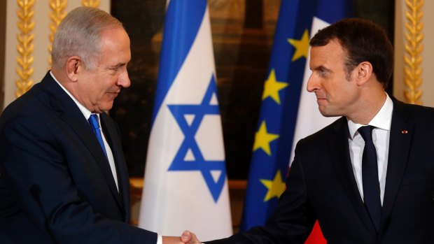 French President Emmanuel Macron, right, and Israeli Prime Minister Benjamin Netanyahu in Paris on Sunday. 