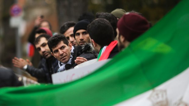 Demonstrators protest against the current government in Iran near the Iranian embassy in Berlin, Germany, on Tuesday.