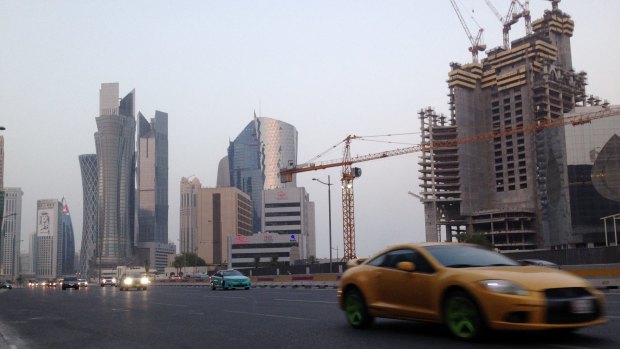 A sports car drives through downtown Doha on Monday.