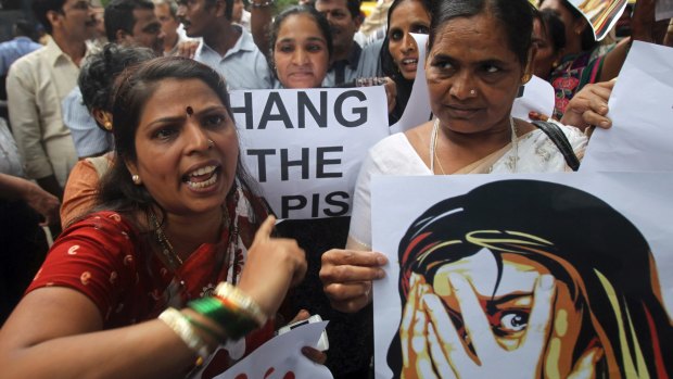 Indian activists shout slogans as they protest against the gang rape of a 22-year-old woman photojournalist in India in 2013. 