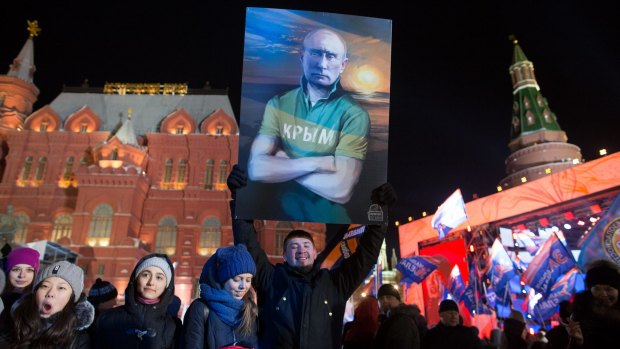 Supporters of Vladimir Putin celebrate at a rally near the Kremlin in Moscow on Sunday.