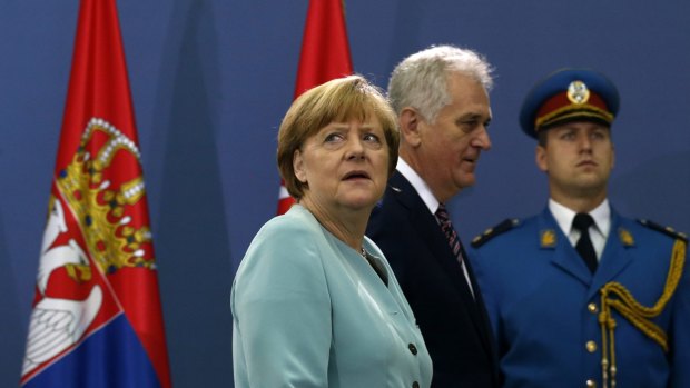 Under pressure: German Chancellor Angela Merkel, left, in Belgrade on Thursday.