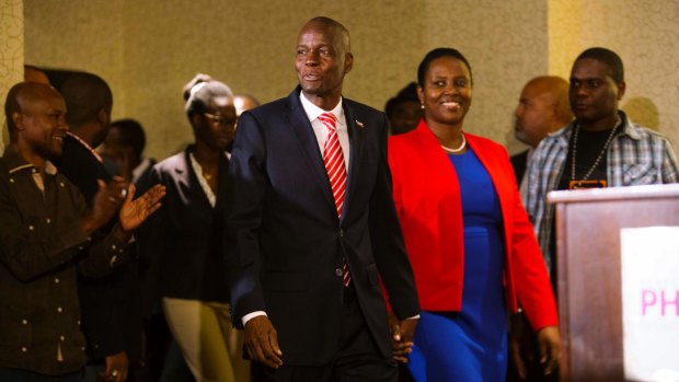 Then President-elect Jovenel Moise arrives with his wife Martine at his first press conference after the announcement of his victory in January.