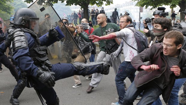 Riot police officers clash with protesters in Paris on Thursday during a demonstration held as part of nationwide strikes in France. 