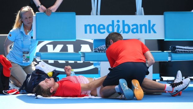 Oliver Anderson receives medical attention during last year's Australia Open, where he claimed the boys' title.