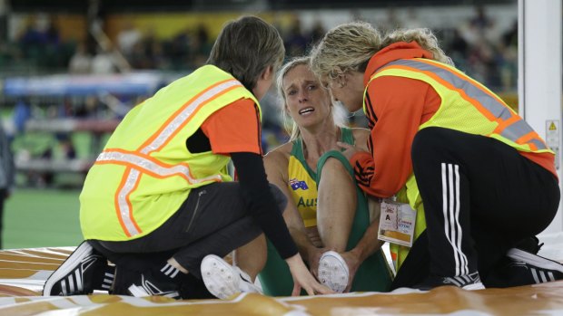 Down, not out: Alana Boyd holds her ankle after injuring herself.