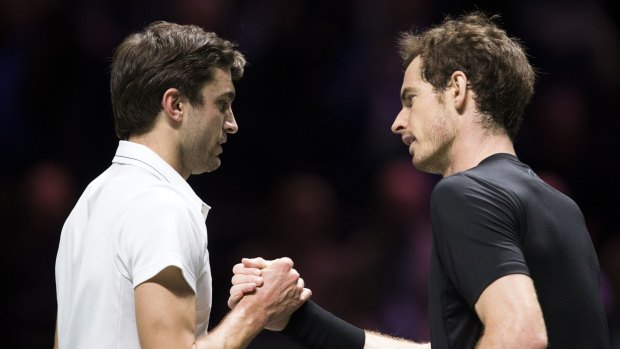 Gilles Simon (left) and Andy Murray shake hands at the end of their match in Rotterdam.