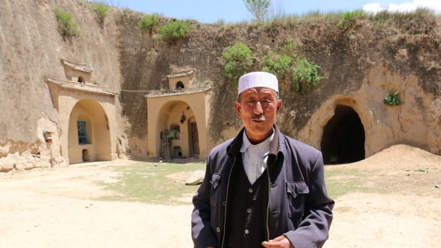 Hai Zhengjun, 64, in front of his former cave dwelling. The land where Hai and his family live has an average annual rainfall of 300-500 millimetres. 