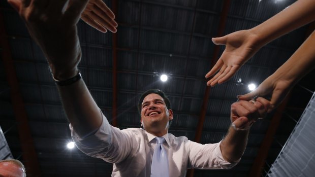 Republican presidential candidate Senator Marco Rubio shakes hands at a rally in Toa Baja, Puerto Rico, on Saturday.