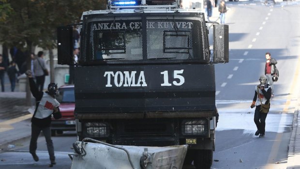 Turkish Kurds throw stones at police in the Turkish capital Ankara.