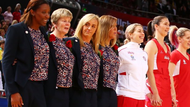 Stoic: England head coach Tracey Neville, centre, and coaching staff sing their national anthem  before the match against Scotland on Friday afternoon.