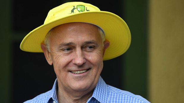 Prime Minister Malcolm Turnbull wears a yellow cricket hat as he receives members of the Australian Women's Cricket Ashes at the Lodge on Wednesday.
