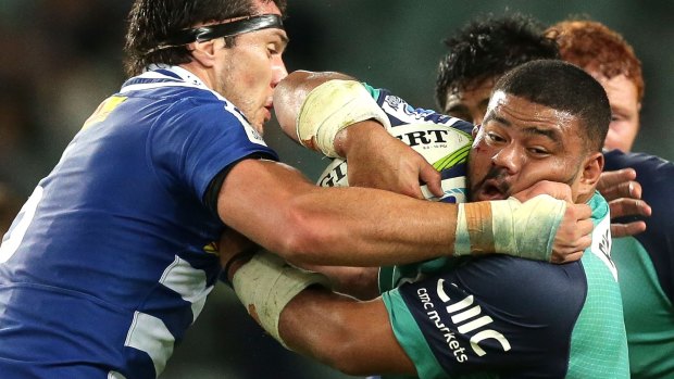 Squeezed out: Tolu Latu of the Waratahs is stopped in his tracks.